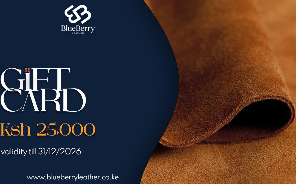 BlueBerry Leather gift card promotional graphic with a dark navy left panel and a close-up brown leather texture on the right. Text reads 'GIFT CARD', 'Ksh 25,000', and 'validity till 31/12/2026'.