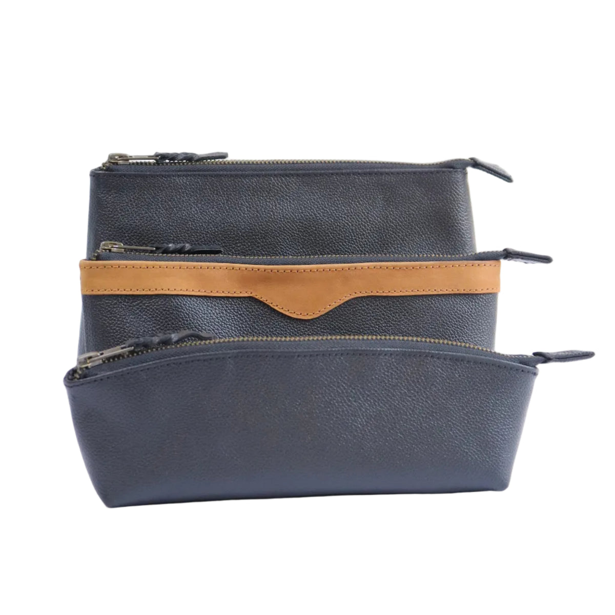 Three zippered pouches stacked vertically on a white background, featuring a dark gray textured leather exterior with a contrasting tan suede stripe and a central tan tab on the middle pouch.