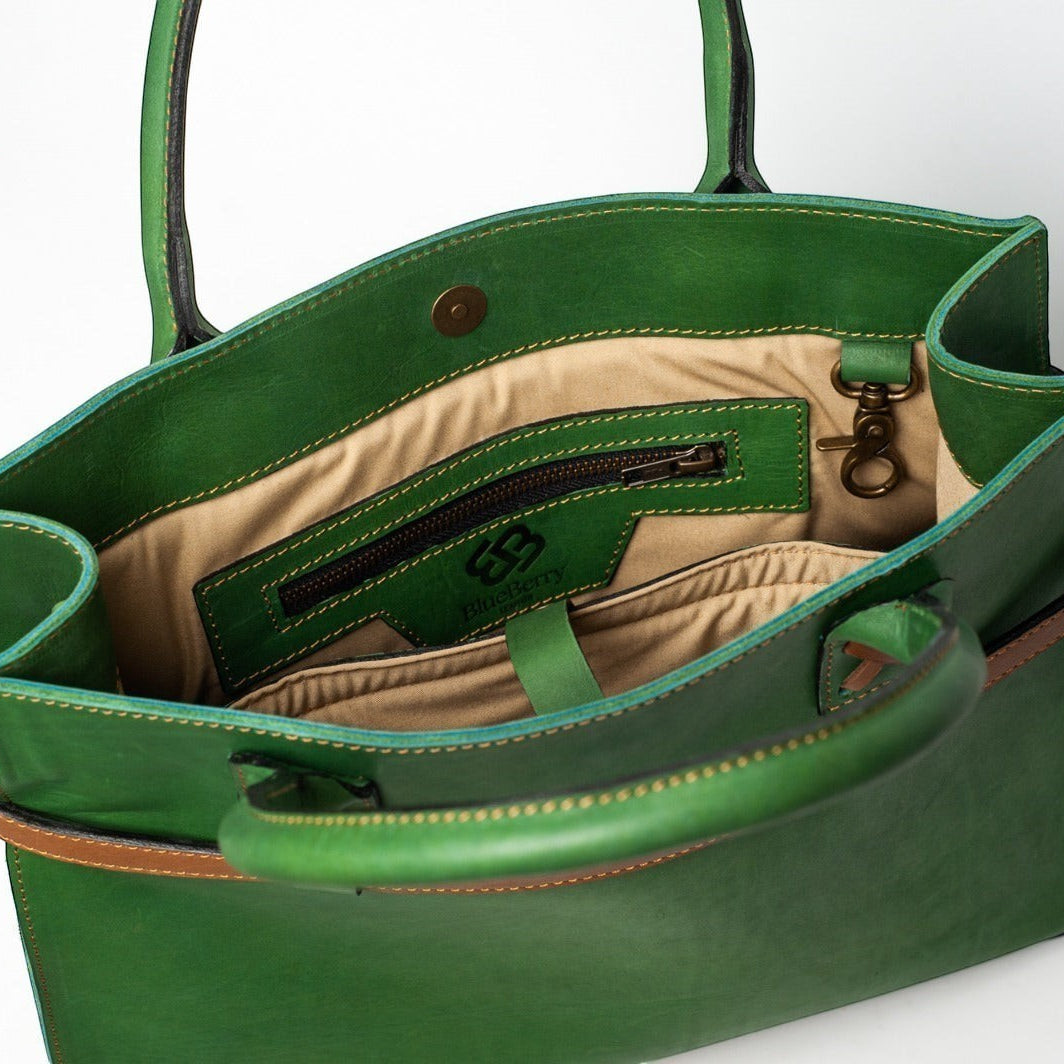 Blueberry Leather Duma Tote in forest green cowhide leather with interior snap button closure and beige lining.