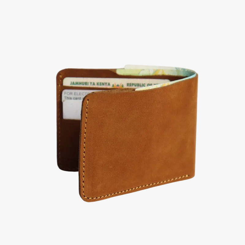 A brown leather bifold wallet with visible stitching, shown open to reveal card slots containing cards and cash, on a light gray background.