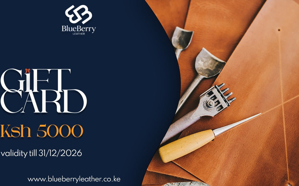 BlueBerry Leather gift card valued at Ksh 5000, featuring a dark navy blue left section with white and gold text, and a warm brown leather background on the right decorated with leatherworking tools.