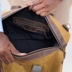 Person opening a brown leather bag with a white background