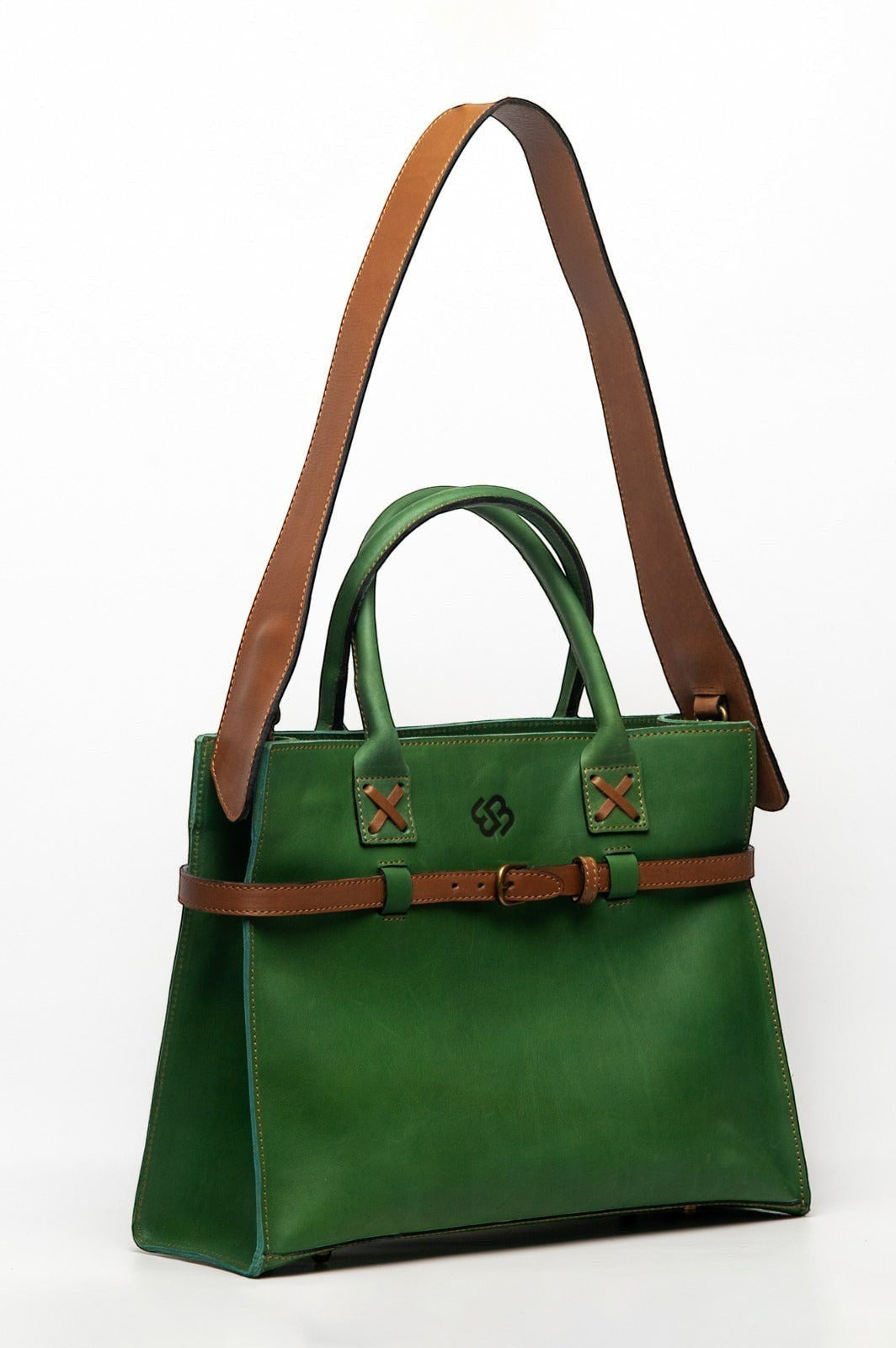 Blueberry Leather Duma Tote in forest green cowhide leather with tan adjustable strap and buckle detail.