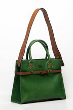 Blueberry Leather Duma Tote in forest green cowhide leather with tan adjustable strap and buckle detail.