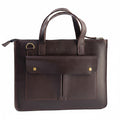 Blueberry Leather Mocca brown leather laptop sleeve with dual carry handles, front pockets, and gold hardware.