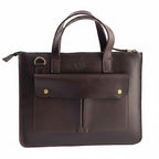 Blueberry Leather Mocca brown leather laptop sleeve with dual carry handles, front pockets, and gold hardware.